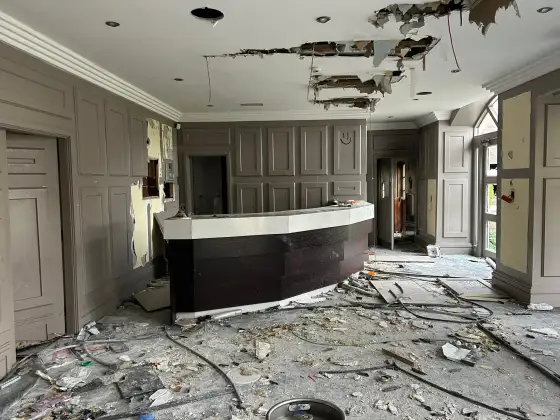Curved bar beneath a damaged ceiling at the abandoned Airth Castle and hotel complex.