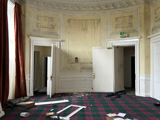 Ornate curved room with damaged plaster at the abandoned Airth Castle and hotel complex.
