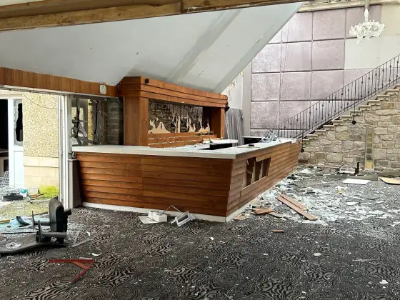 Damaged reception and broad staircase at the abandoned Airth Castle and hotel complex.