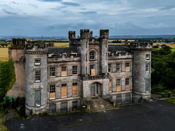 Aerial view of the boarded-up castle at the abandoned Airth Castle and hotel complex.